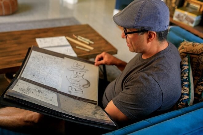 A comic illustrator looking at his collection