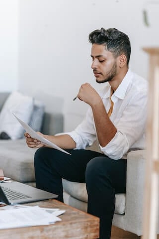 A game designer looking at the draft of his report